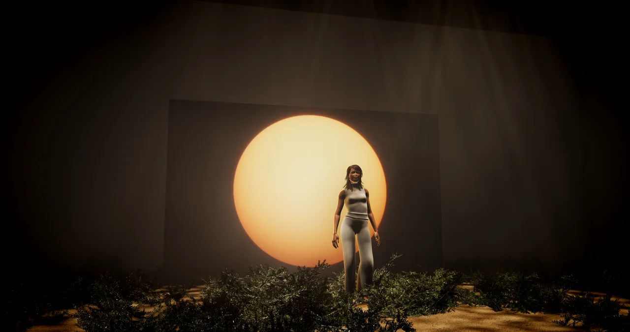 Wide view of the Blessed Assurance set: singer centred in front of the sun LED and orange wall, brush in the foreground