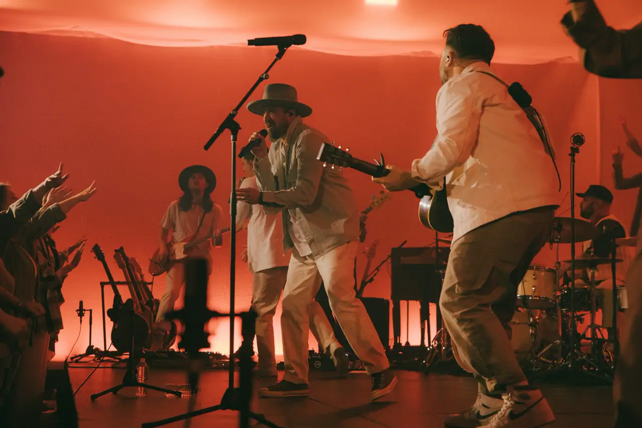 Cody Carnes and band performing in warm orange light during the Firm Foundation recording